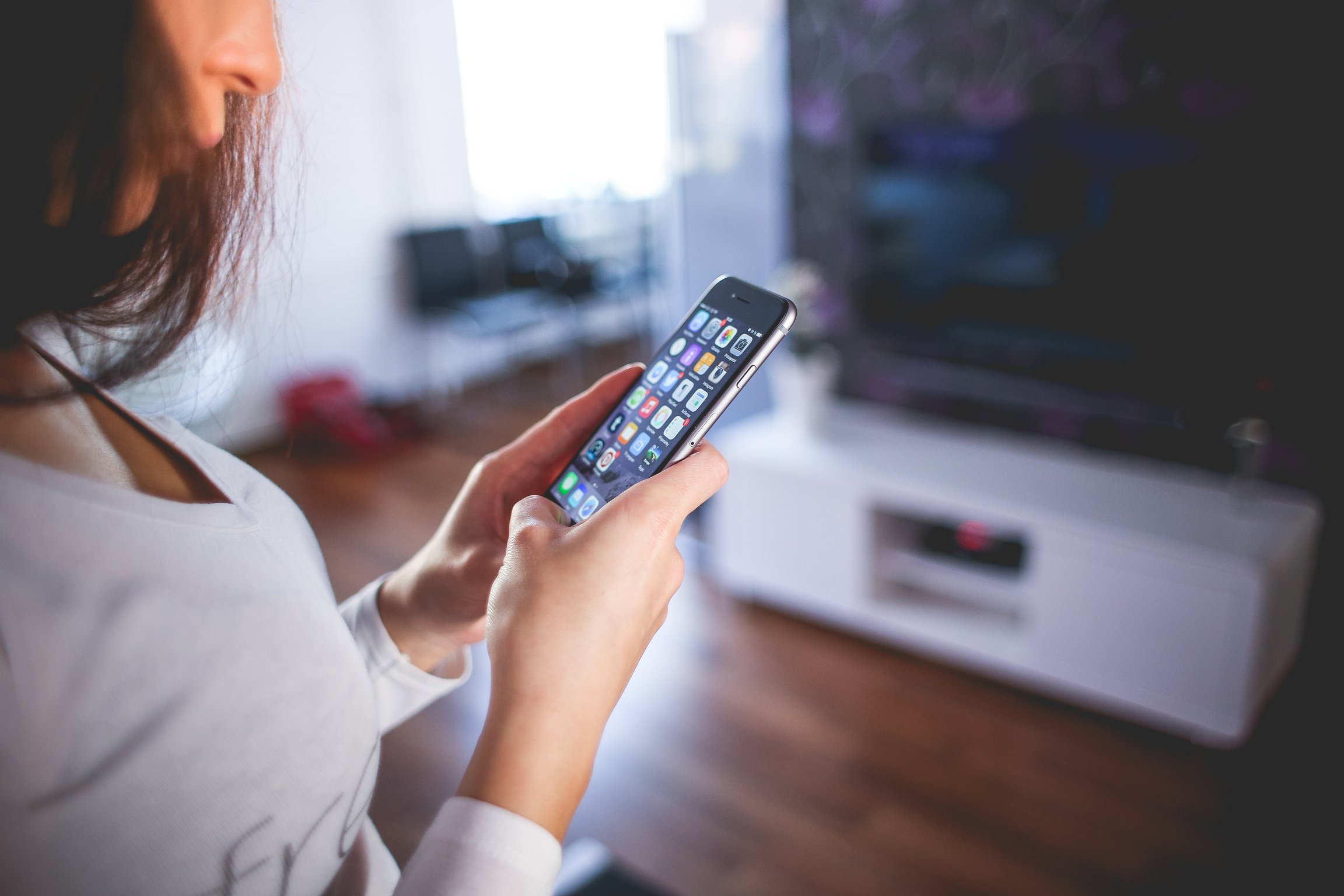 Woman Wearing White V Neck Shirt Using Space Gray Iphone 6